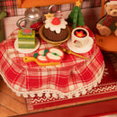 De met kerstlekkernijen gedekte tafel van de Robotime Christmas Eve Party