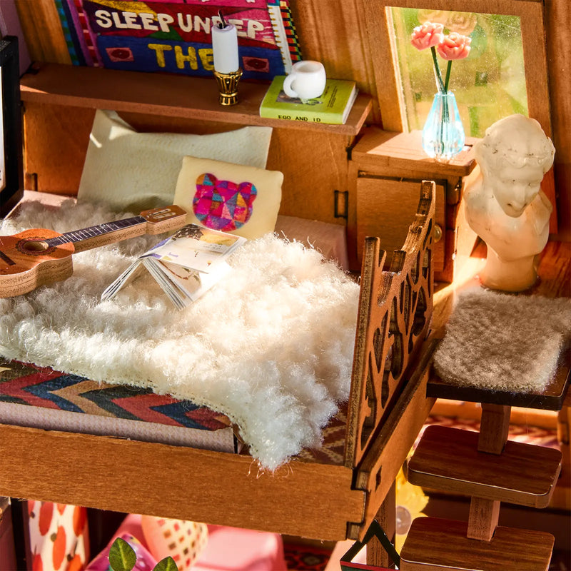 De loft met bed en decoraties in de Robotime A-Frame Cabin