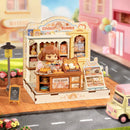 Sfeervolle presentatie van de Robotime Cookii Bunny’s Cookie Shop, miniatuurhuisje van een koekjeswinkel met Cookii Bunny achter de toonbank