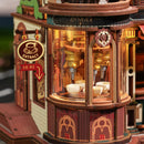 De machine die kopjes koffie vult beneden in de toren van de Robotime Dream Coffee Factory