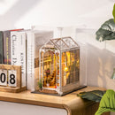 Een book nook in de Robotime Dust Cover WD1001 op een kast met boeken ernaast
