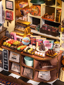 Close-up van de balie en lekkernijen in de Robotime Henry’s Chocolate