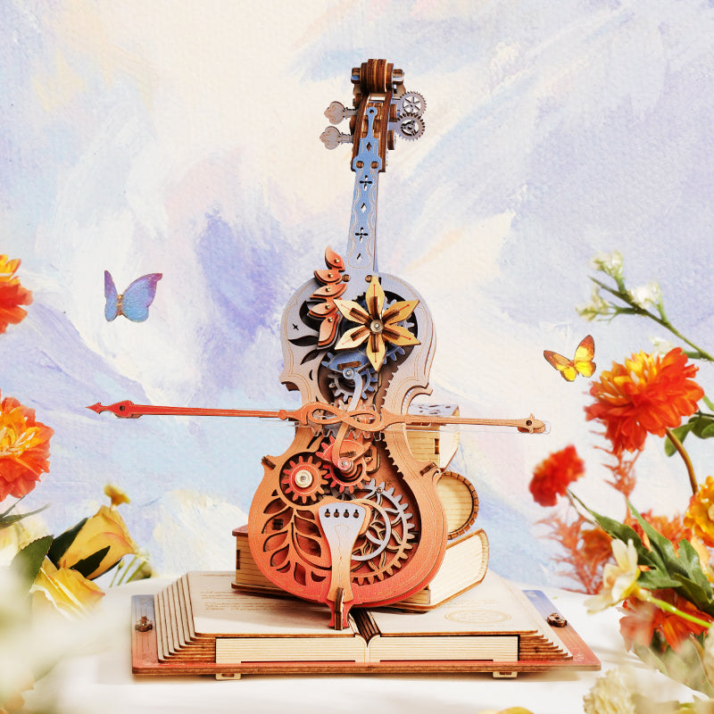 Sfeervolle presentatie van de Robotime  Robotime Magic Cello - Symphony of Gorgeous Dreams met vlinders, bloemen en blauwe lucht op de achtergrond