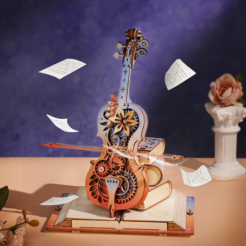 Sfeervolle presentatie van de Robotime  Robotime Magic Cello - Symphony of Gorgeous Dreams met een paarse achtergrond, omringd door vliegende vellen muziekpapier