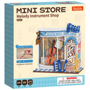 Voorkant verpakking van de Robotime Melody Instrument Shop, bouwpakket voor een miniatuurhuisje van een muziekwinkel