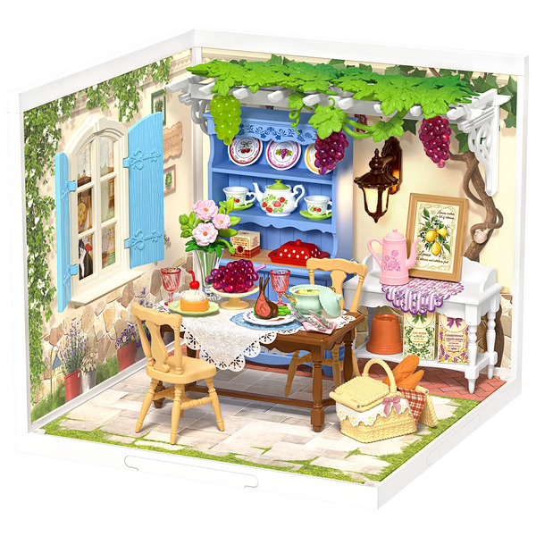 Productfoto van de Robotime Midsummer Dream Yard, kunststof miniatuur terras met gedekte tafel, pergola en meubelen