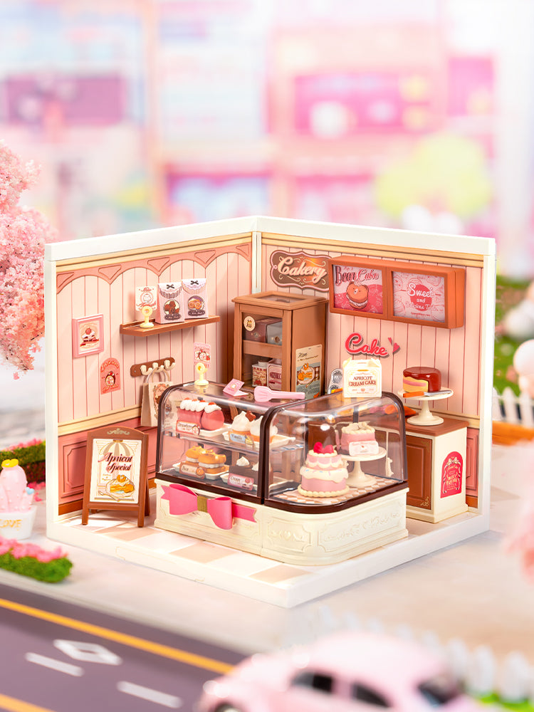 Sfeervolle presentatie van de Robotime Tasty Cake Shop, kunststof miniatuurhuisje van een schattig roze taartwinkeltje